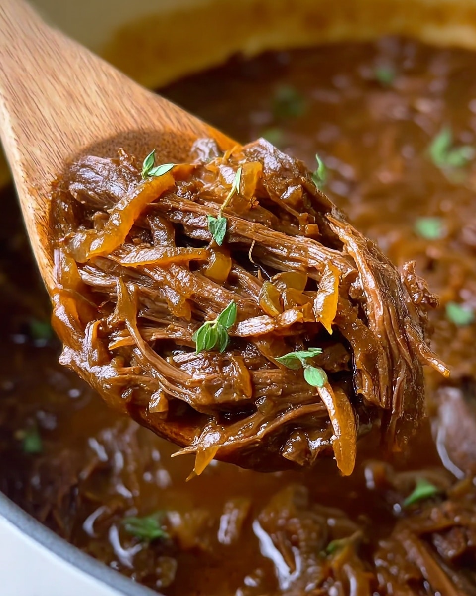 A close-up view of shredded braised beef mixed with caramelized onions, sitting in a rich, glossy brown sauce. The beef strands are pulled apart, showing the tender texture, with some small green herb leaves scattered on top for a fresh look. The beef and onions are on a wooden spoon above a pot filled with more of the same mixture. The background is a smooth white marbled texture. photo taken with an iphone --ar 4:5 --v 7