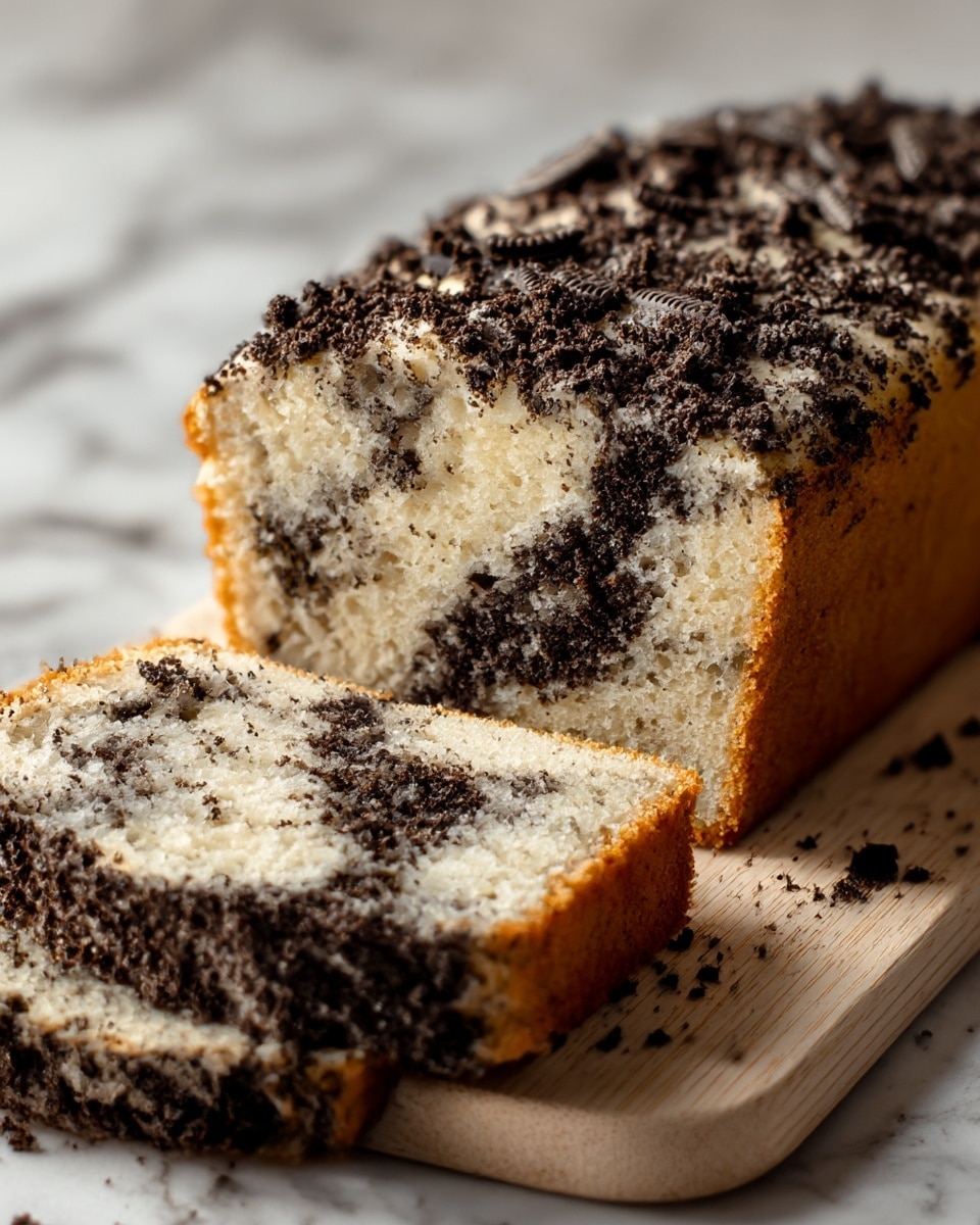 A close-up of a soft, moist loaf cake on a light wooden board, with one thick slice and a smaller piece cut off in front. The cake has two main layers: a pale, creamy vanilla base with a spongy texture, mixed with irregular patches and swirls of dark, crumbly chocolate cookie chunks throughout. The top is generously sprinkled with crushed dark chocolate cookie pieces, creating a rough, crumbly surface. The edges of the cake show a golden-brown baked crust that contrasts with the lighter interior. The scene has a soft, natural light and a white marbled surface in the background. photo taken with an iphone --ar 4:5 --v 7