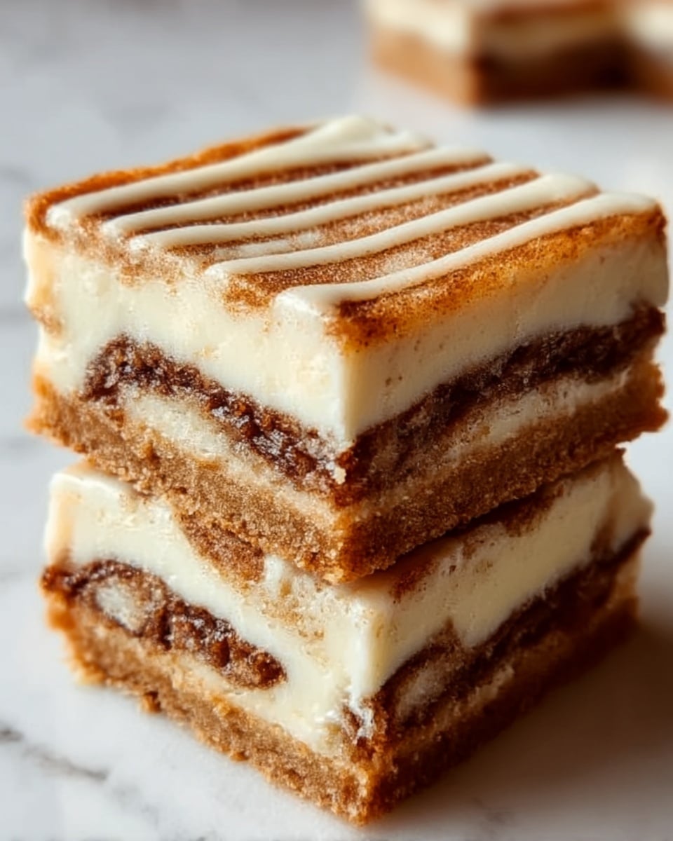 Two square pieces of dessert stacked on top of each other, each with three visible layers. The top and bottom layers are light golden brown with a crumbly texture, and the middle layer is a smooth white cream. Between the cream and bottom crust, there is a dark brown cinnamon swirl that looks soft and gooey. The dessert is placed on a white marbled surface, and the photo is taken with an iphone --ar 4:5 --v 7